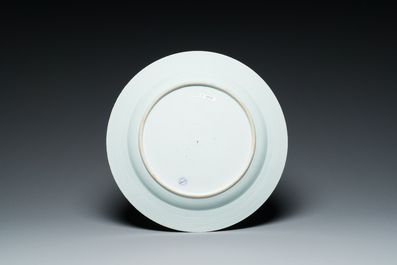 A Chinese famille rose dish with two ladies and a boy in a garden, Yongzheng