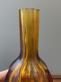 A Chinese facetted translucent green-coloured Peking glass bottle vase, Qianlong mark, 19th C.