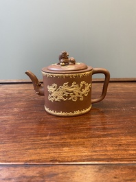 A Chinese Yixing stoneware teapot and cover with an applied dragon, Kangxi