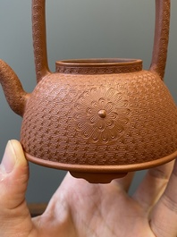 A Chinese Yixing stoneware carved 'chrysanthemum' teapot and cover, Kangxi