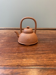 A Chinese Yixing stoneware carved 'chrysanthemum' teapot and cover, Kangxi