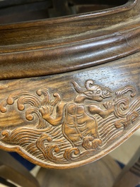 A Chinese wood circular incense stand with mythic animals, 'xiangji', Ming