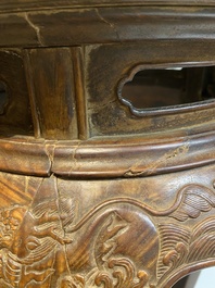 Een Chinese huanghuali houten sokkel voor een wierookbrander met decor van mythische dieren, 'xiangji', Ming