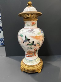 Un vase en porcelaine de Chine famille verte et un en gr&egrave;s de Yixing &eacute;maill&eacute; aux montures en bronze dor&eacute;, 19&egrave;me