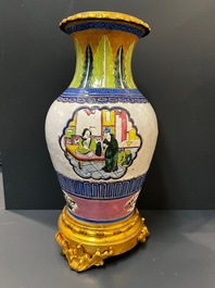 A Chinese famille verte vase and an enamelled Yixing stoneware vase with gilt bronze mounts, 19th C.