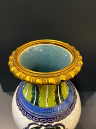 A Chinese famille verte vase and an enamelled Yixing stoneware vase with gilt bronze mounts, 19th C.