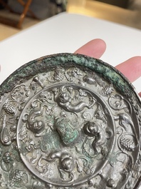 A Chinese silvery bronze 'lion and grapevine' mirror, Tang