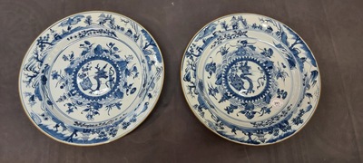 A pair of Chinese blue and white dishes with raised central medallions, Kangxi