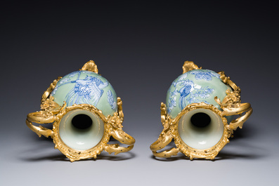 A pair of Chinese blue and white celadon-ground vases with gilt bronze mounts, 19th C.