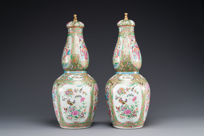 A pair of Chinese Canton famille rose double gourd vases and covers, 19th C.