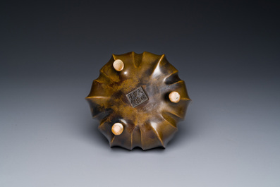 A Chinese bronze lotus-shaped tripod censer, Xuande mark, 18/19th C.