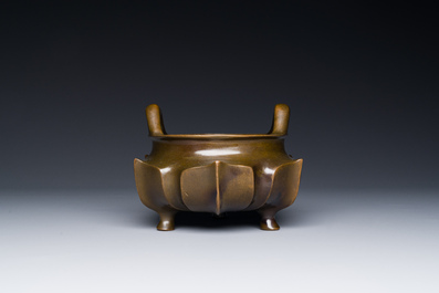 A Chinese bronze lotus-shaped tripod censer, Xuande mark, 18/19th C.