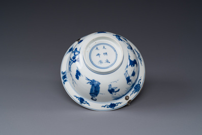 A Chinese blue and white bowl depicting playing boys and ladies with a mounted silver handle, Chenghua mark, Kangxi