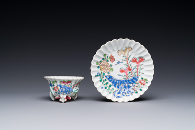 A Chinese famille rose relief-decorated cup and saucer, Yongzheng