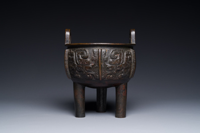 A Chinese archaistic bronze tripod censer on wooden stand, 'ding', Song/Ming