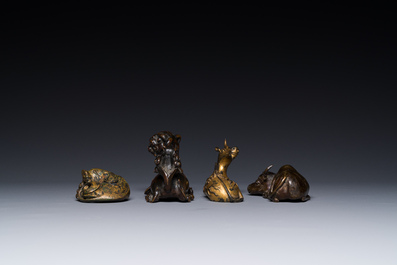 A group of four Chinese gilt bronze paper-weights, Ming/Qing