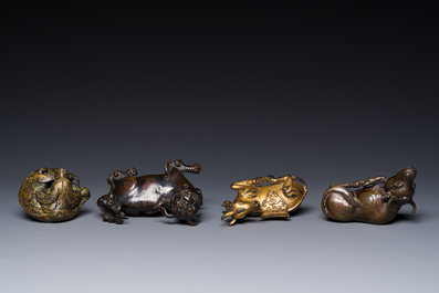 A group of four Chinese gilt bronze paper-weights, Ming/Qing