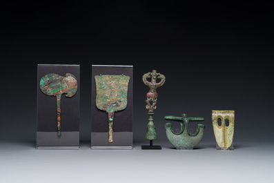 A collection of three bronze axes, a mirror and an anthropomorphic idol with two dragon heads, Luristan, 2000 B.C and earlier