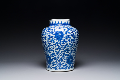 A Chinese blue and white 'lotus scroll' jar with wooden cover and stand, Kangxi