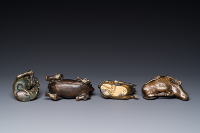 A group of four Chinese gilt bronze paper-weights, Ming/Qing