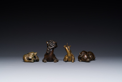 A group of four Chinese gilt bronze paper-weights, Ming/Qing