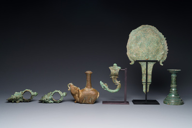 A collection of bronze sculptures, palanquin hooks and a candlestick holder, Cambodia, 13th C. and earlier