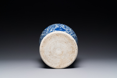 A Chinese blue and white 'lotus scroll' jar with wooden cover and stand, Kangxi