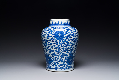 A Chinese blue and white 'lotus scroll' jar with wooden cover and stand, Kangxi