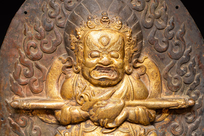 A Tibetan gilt copper 'Mahakala' plaque, 19th C.