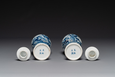 A pair of Chinese blue, white and copper-red vases and covers, Kangxi mark, 19th C.