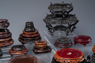A large collection of 54 varied Chinese wooden stands, 19/20th C.