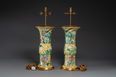 A pair of Chinese verte biscuit 'gu' vases with gilt bronze lamp mounts, 19th C.