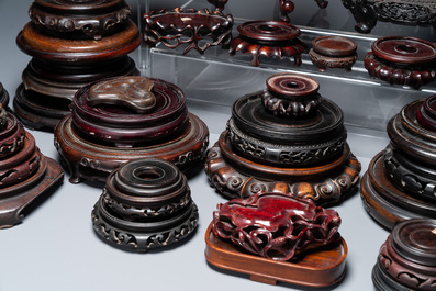 A large collection of 58 varied Chinese wooden stands, 19/20th C.