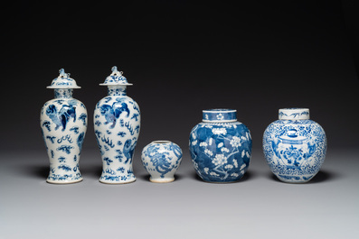 A pair of Chinese blue and white covered vases and three jars, 19th C.