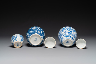 A pair of Chinese blue and white covered vases and three jars, 19th C.