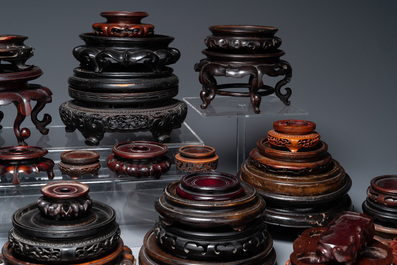 A large collection of 58 varied Chinese wooden stands, 19/20th C.