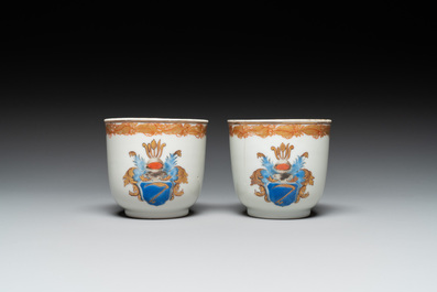 A pair of monogrammed Chinese puce-enamelled plates and a pair of armorial cups and saucers, Yongzheng/Qianlong