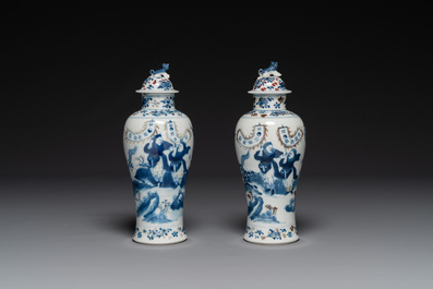 A pair of Chinese blue, white and copper-red vases and covers, Kangxi mark, 19th C.