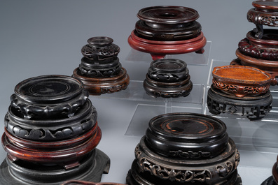 A large collection of 54 varied Chinese wooden stands, 19/20th C.