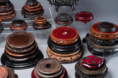 A large collection of 54 varied Chinese wooden stands, 19/20th C.