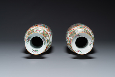 A pair of Chinese Canton famille rose vases with wooden stands, 19th C.