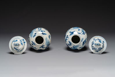 A pair of Chinese blue and white covered vases and three jars, 19th C.