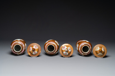 A Chinese capucin-brown-ground famille rose garniture of five vases with floral design, Qianlong