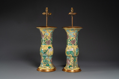 A pair of Chinese verte biscuit 'gu' vases with gilt bronze lamp mounts, 19th C.