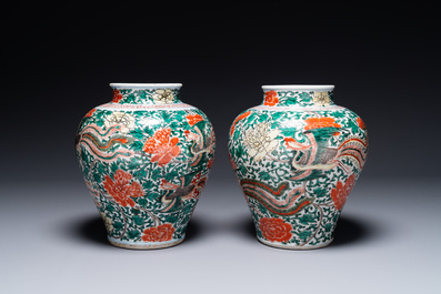 A pair of Chinese wucai 'phoenix and peony scroll' vases, Transitional period