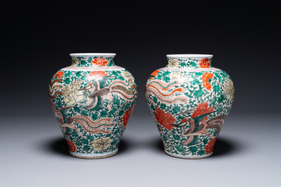 A pair of Chinese wucai 'phoenix and peony scroll' vases, Transitional period