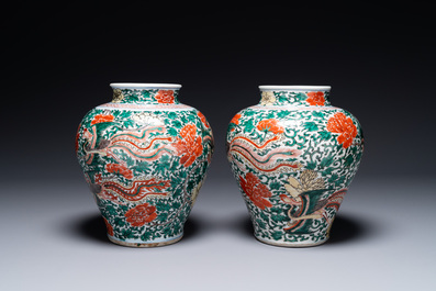 A pair of Chinese wucai 'phoenix and peony scroll' vases, Transitional period