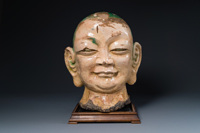 An imposing Chinese sancai glazed stoneware head of a monk, Yuan/Ming