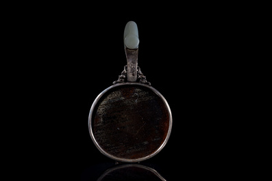 A Chinese white jade-mounted and gemstone inlaid silver hand mirror, 19/20th C.