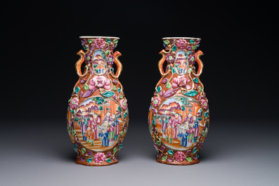 A pair of Chinese Canton famille rose 'mandarin subject' vases with floral relief design, Qianlong